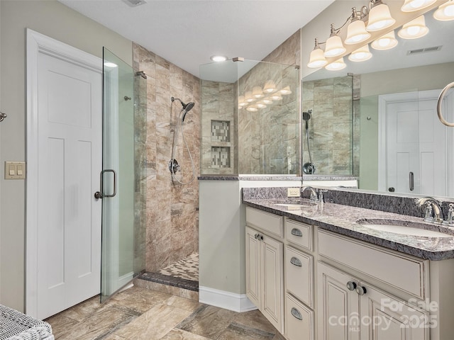 bathroom featuring an enclosed shower and vanity