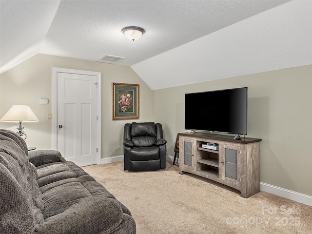 living room with vaulted ceiling, light carpet, and a textured ceiling