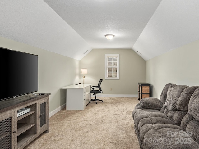 carpeted office space featuring lofted ceiling and a textured ceiling