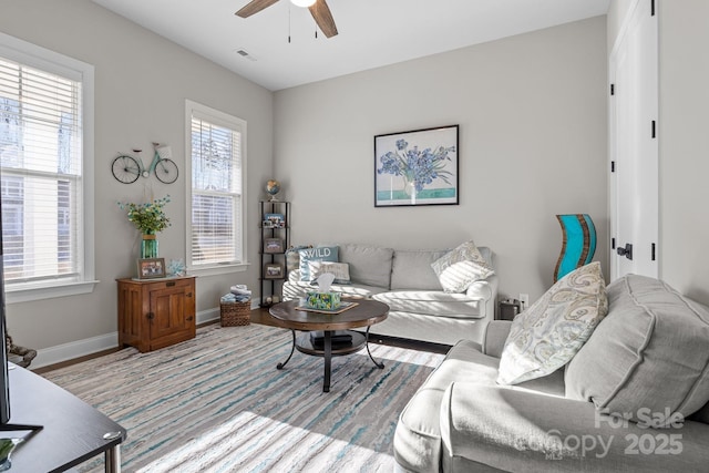 living room with light hardwood / wood-style flooring and ceiling fan