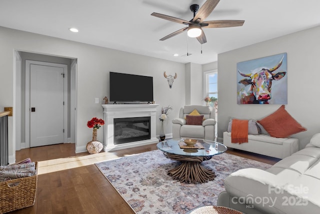 living room featuring hardwood / wood-style floors and ceiling fan