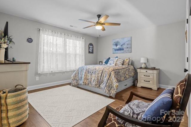 bedroom with ceiling fan and dark hardwood / wood-style floors