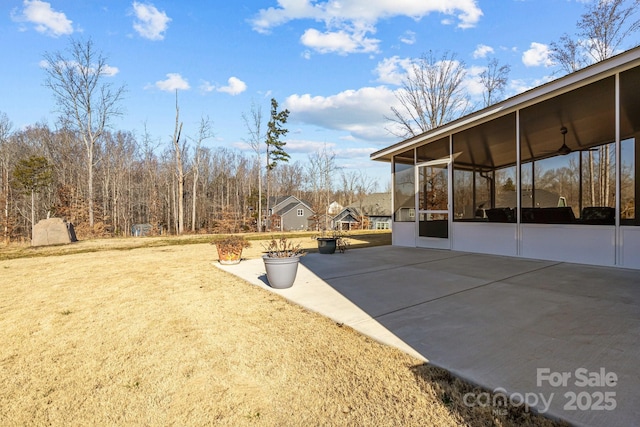 view of yard featuring a patio and a sunroom