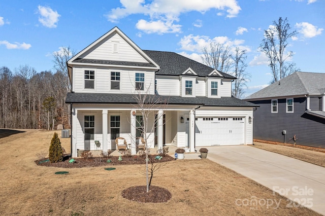 front of property with a porch, a garage, and a front yard