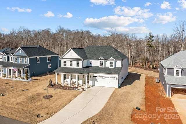 view of property with a porch, a garage, and a front lawn