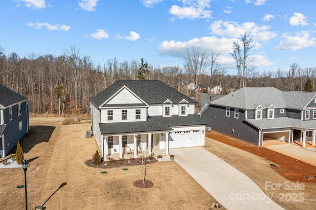 view of property featuring a garage and a porch