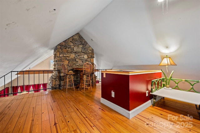 interior space with lofted ceiling and hardwood / wood-style flooring