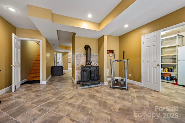 unfurnished living room featuring a wood stove