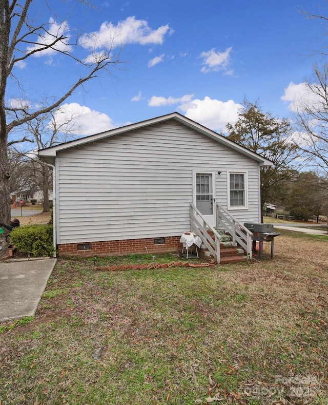 view of property exterior with a lawn