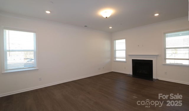 unfurnished living room with dark hardwood / wood-style flooring and ornamental molding