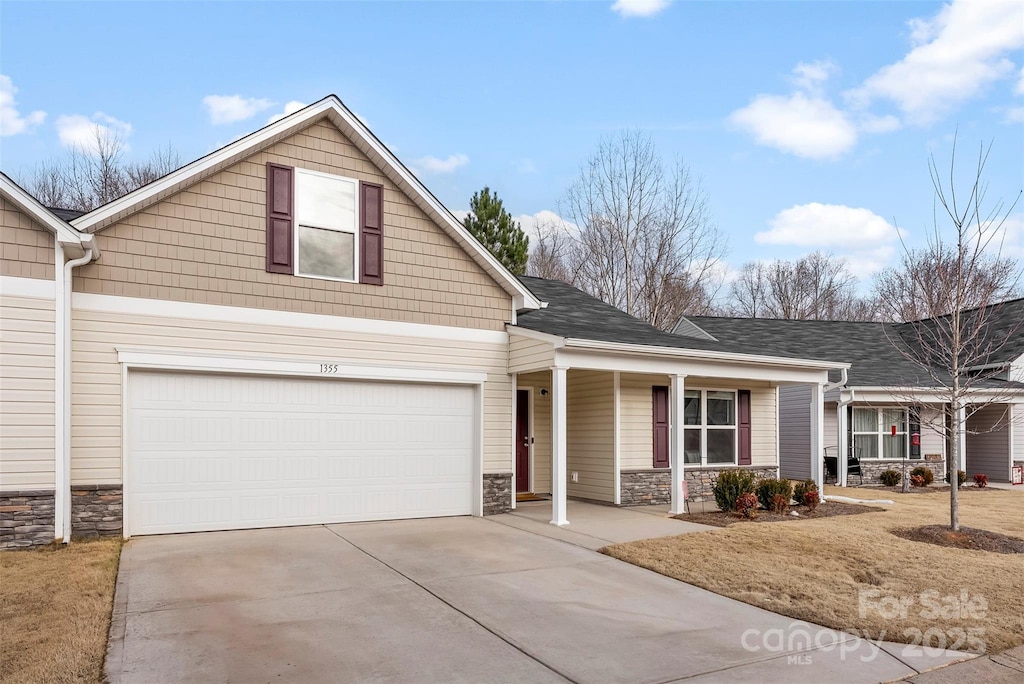 view of front of property with a garage and covered porch