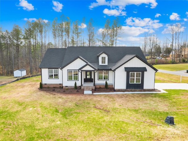 modern farmhouse featuring a front yard and covered porch