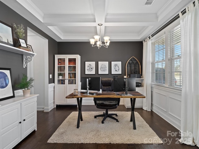 office space featuring dark wood-type flooring, coffered ceiling, ornamental molding, a notable chandelier, and beamed ceiling