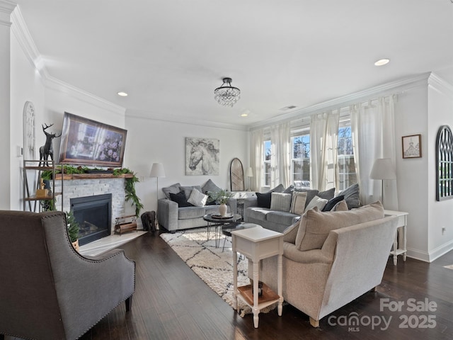 living room with crown molding, a stone fireplace, and dark hardwood / wood-style floors