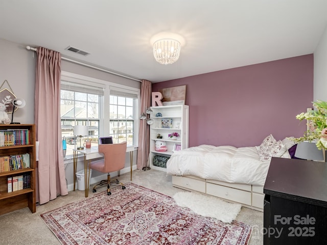 carpeted bedroom with a chandelier