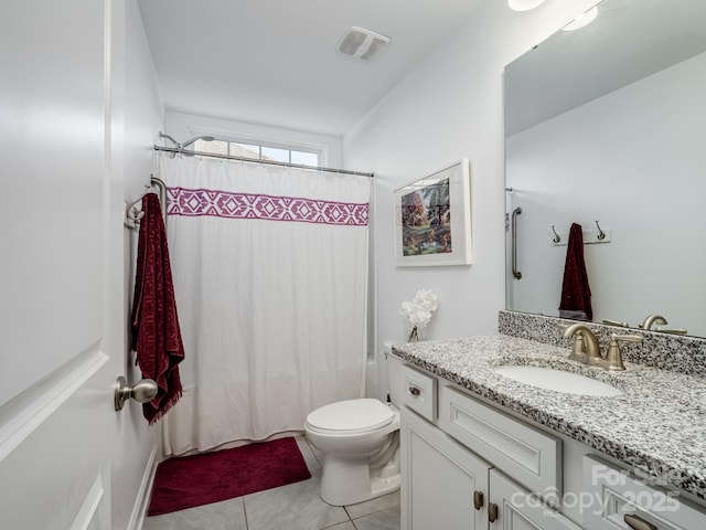 bathroom with vanity, tile patterned flooring, and toilet