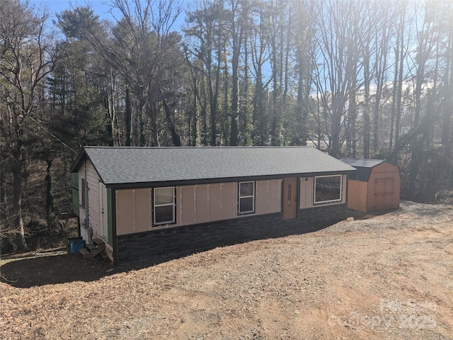 view of front of house featuring a shed and central air condition unit