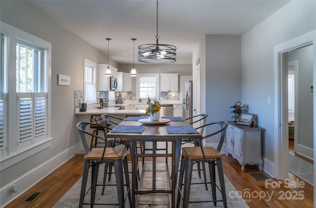 dining area with dark hardwood / wood-style flooring