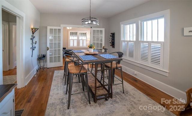 dining room featuring dark wood-type flooring and french doors