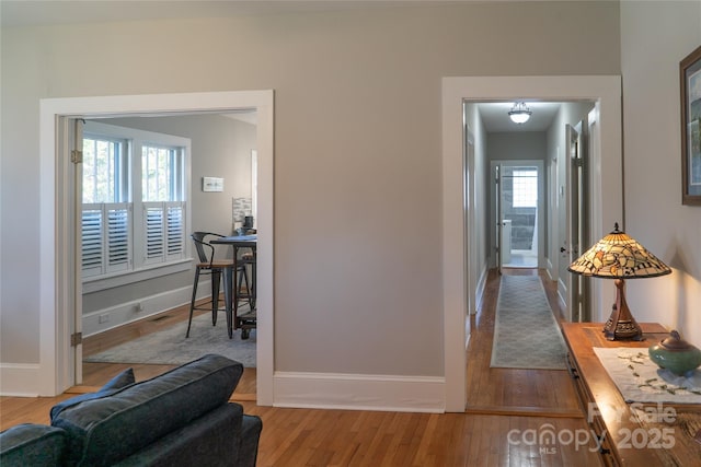 hall with hardwood / wood-style floors