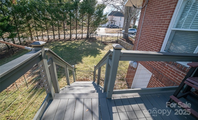 wooden terrace with a lawn