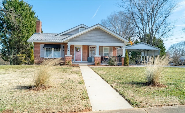 craftsman-style home with a front lawn, a carport, and a porch