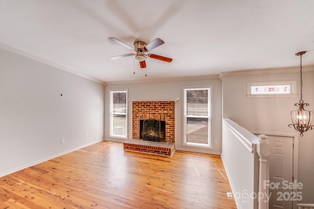 unfurnished living room with plenty of natural light, light wood-style flooring, and a fireplace