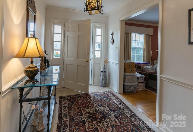 entrance foyer featuring hardwood / wood-style floors and crown molding