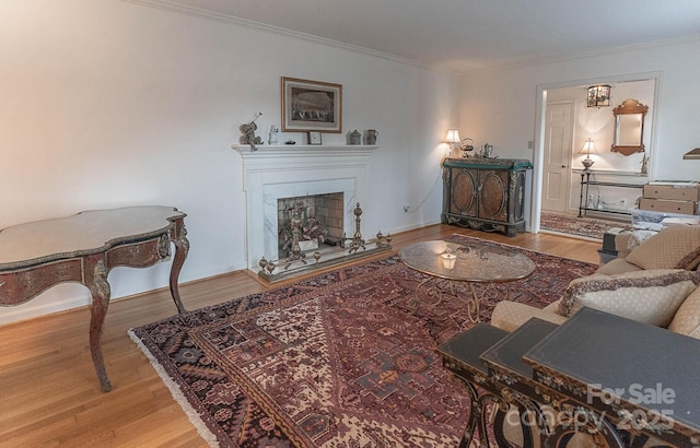 living room with hardwood / wood-style flooring and crown molding