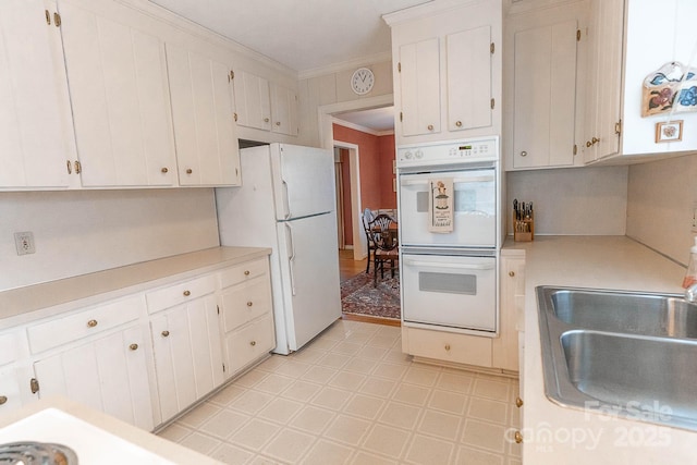 kitchen featuring white cabinetry, white appliances, ornamental molding, and sink