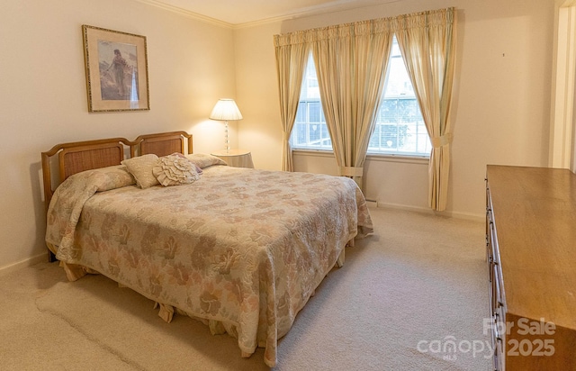 bedroom with crown molding and light carpet