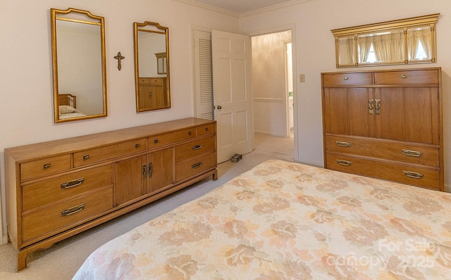 carpeted bedroom with ornamental molding