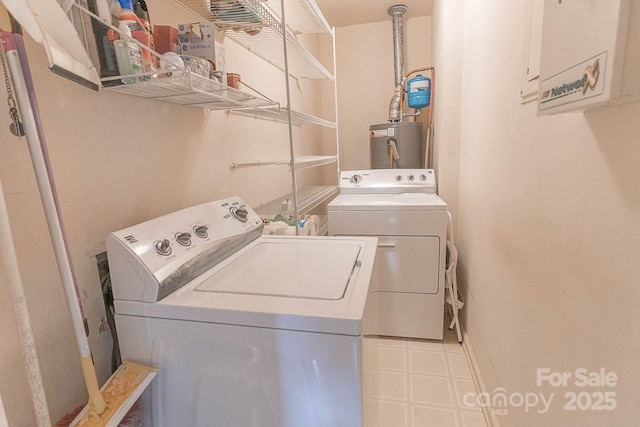 laundry area with washing machine and dryer and water heater