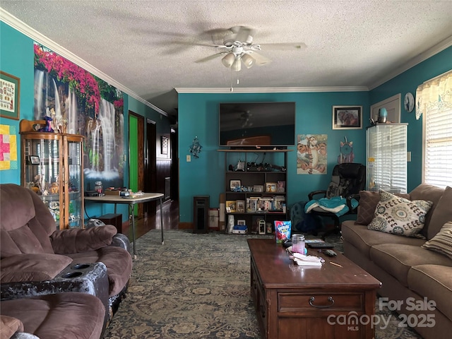 carpeted living area with a ceiling fan, crown molding, and a textured ceiling