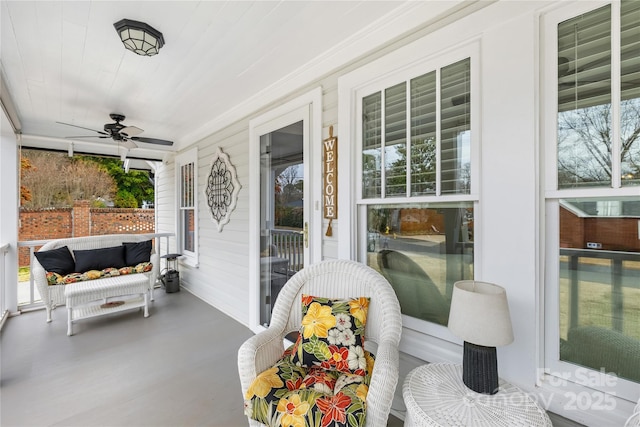 sunroom / solarium featuring ceiling fan