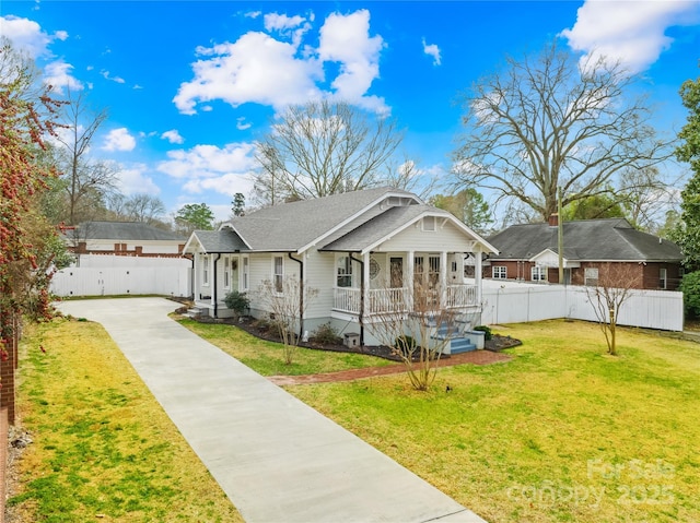 view of front of house featuring a front lawn and covered porch