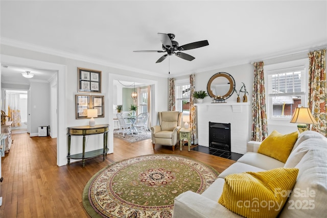 living room with ceiling fan, ornamental molding, hardwood / wood-style floors, and a wealth of natural light