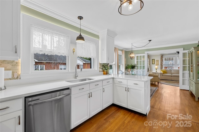 kitchen featuring white cabinetry, dishwasher, sink, and kitchen peninsula