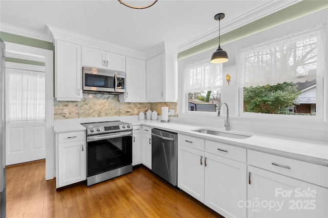 kitchen with white cabinetry, sink, and stainless steel appliances