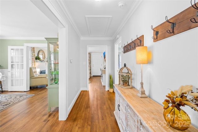 hall featuring hardwood / wood-style floors and ornamental molding