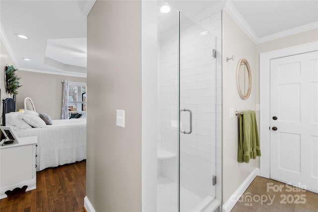 bathroom featuring crown molding, hardwood / wood-style floors, and an enclosed shower