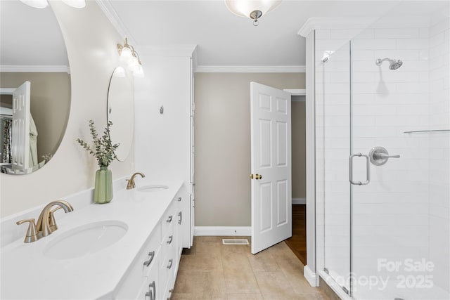 bathroom featuring a shower with door, ornamental molding, and vanity