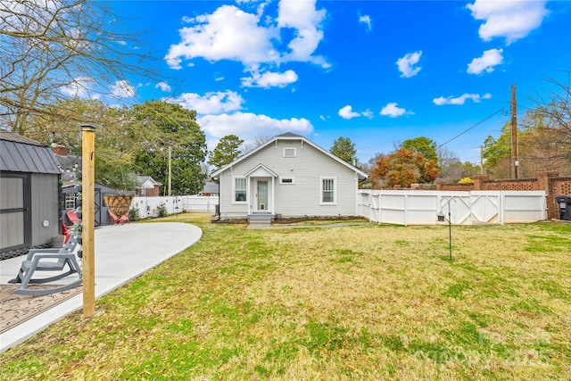 rear view of property featuring a yard and a patio area