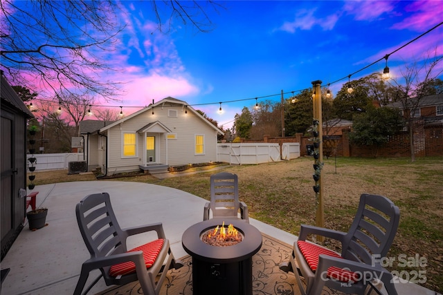 exterior space featuring an outdoor fire pit, a yard, central AC unit, and a patio