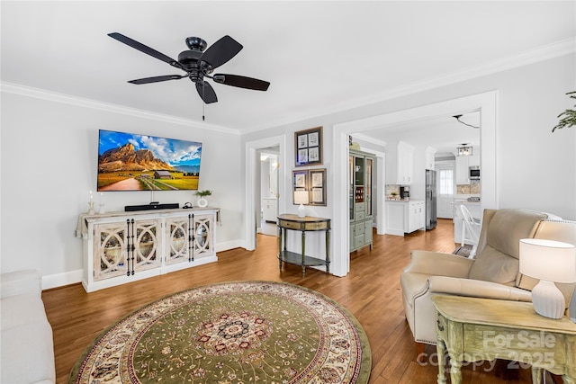 living room featuring crown molding, ceiling fan, and hardwood / wood-style floors