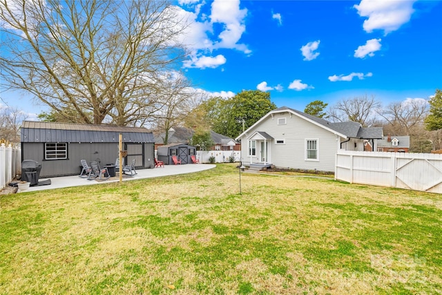 view of yard with a patio and a storage unit