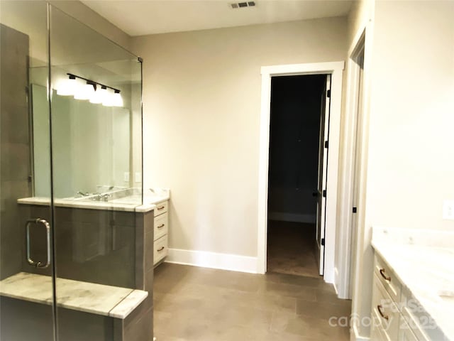 bathroom featuring vanity and a shower with shower door