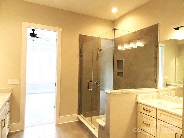 bathroom with ceiling fan, vanity, and a shower with shower door