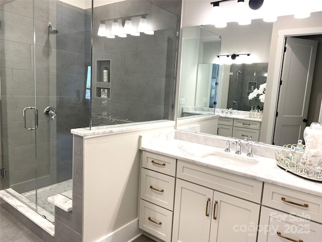 bathroom with a stall shower and vanity