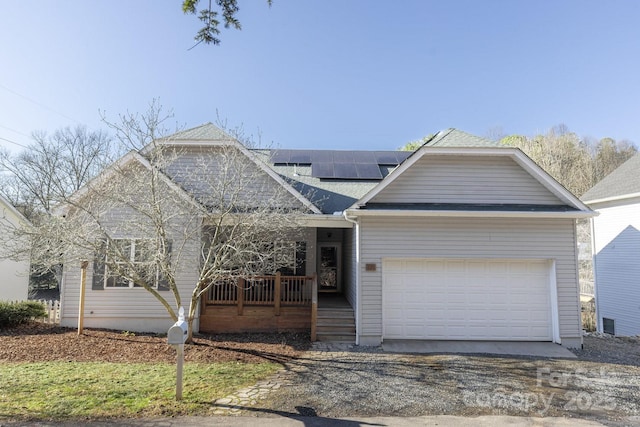 view of front of house with a garage and solar panels